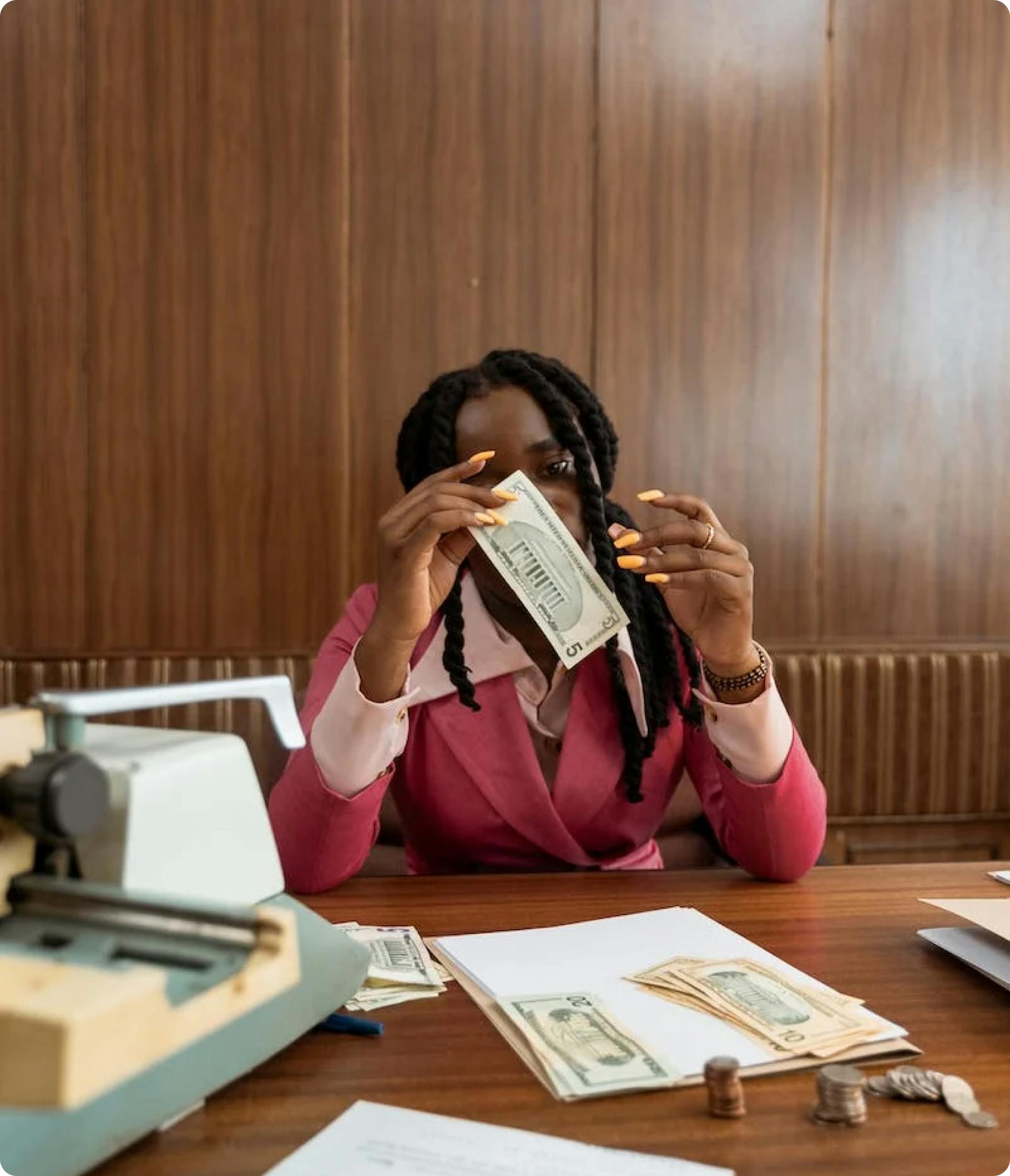 woman sitting at table counting money