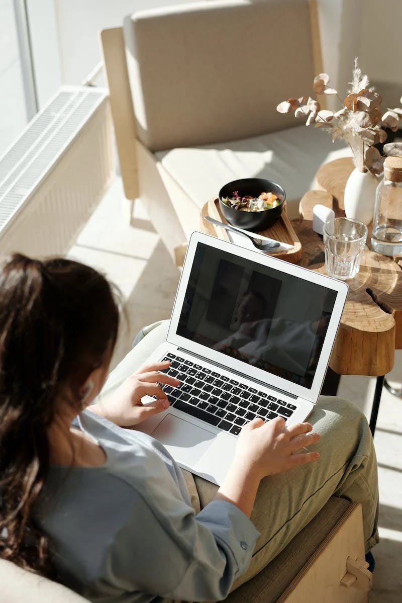 woman turning on her laptop