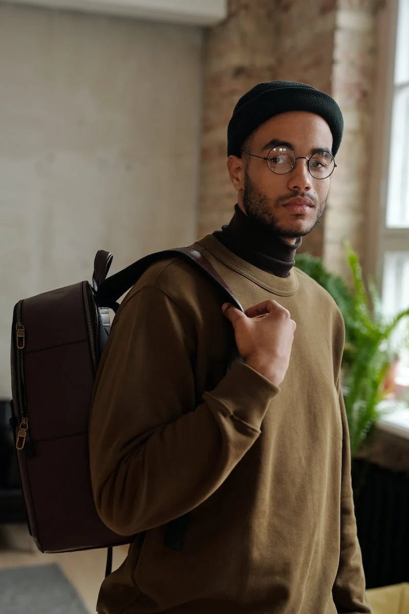 man in office with backpack