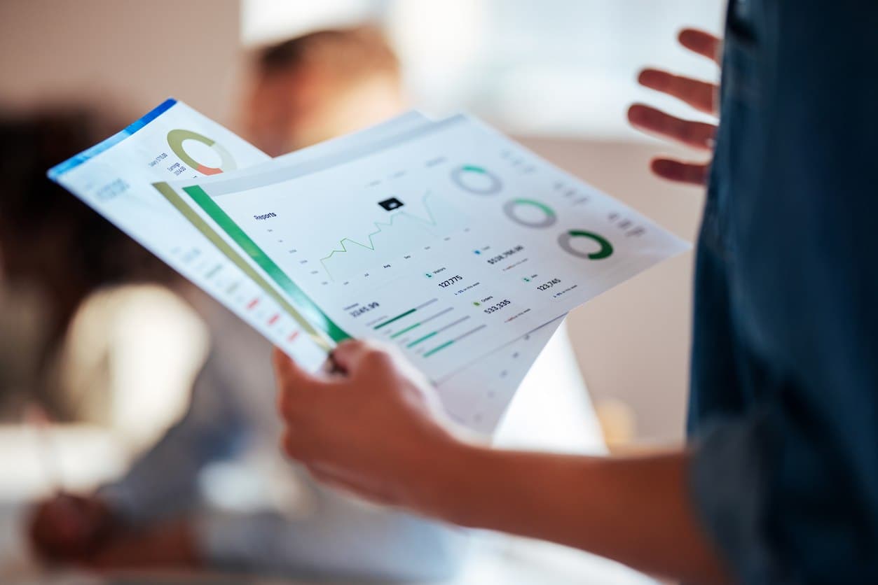 Hands holding papers representing value